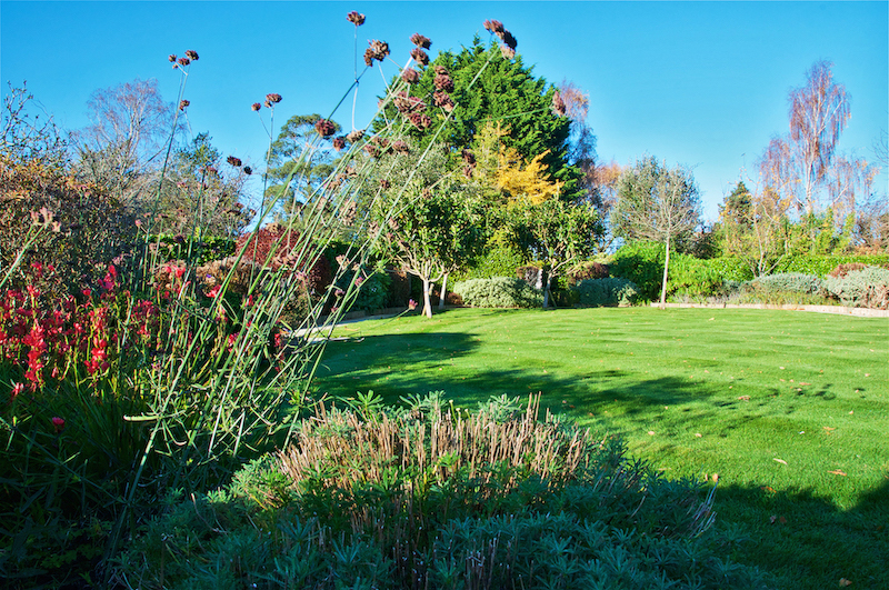 The lawn and flower beds in the gardens at Barnham Manor